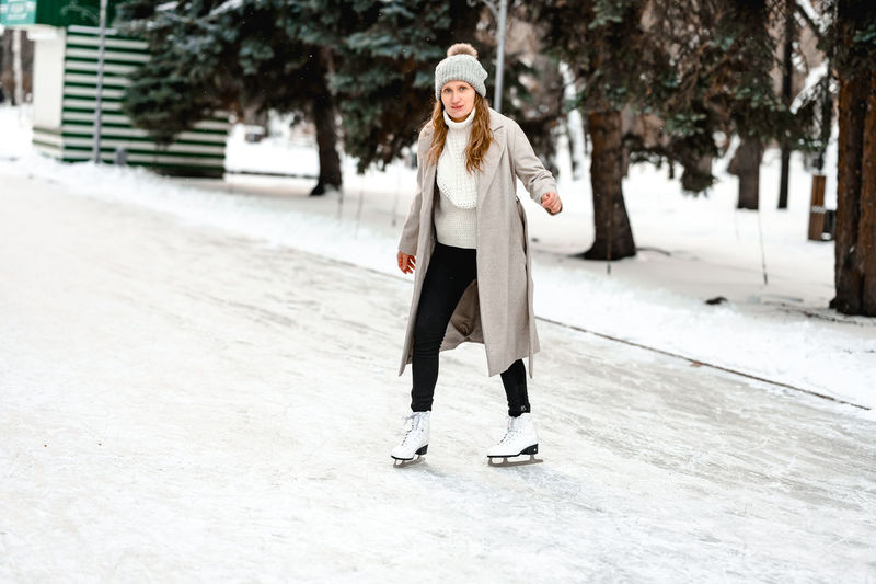 Portrait of young woman standing on snow
