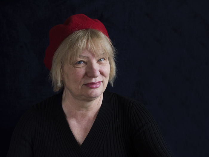 Portrait of mature woman on black background