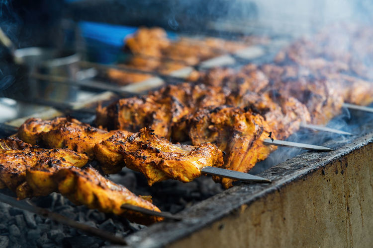 Chicken skew kebab barbeque. traditional indian and paksitan dish cooked on charcoal and flame.