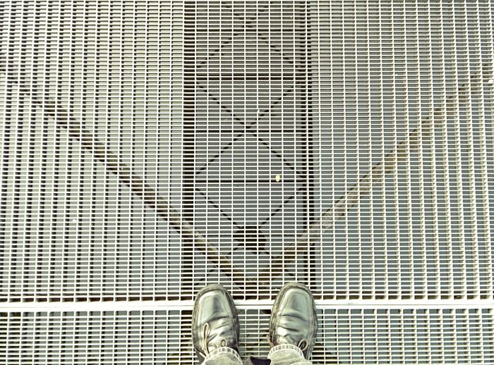 Low section of person standing on tiled floor