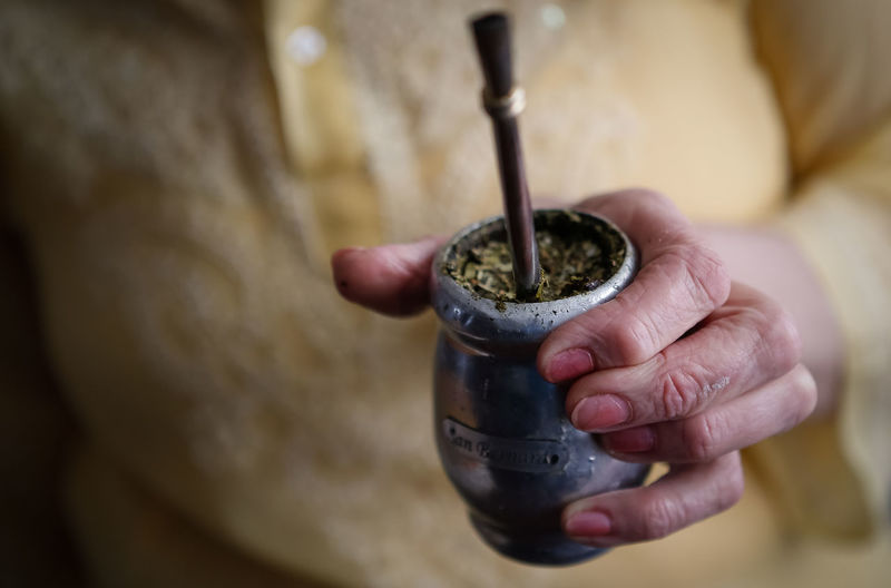 Midsection of woman holding yerba mate