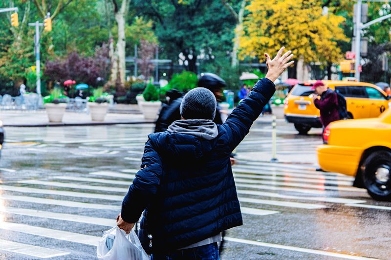 Rear view of woman walking on sidewalk