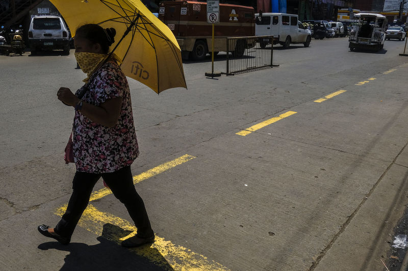 Woman walking on road in city