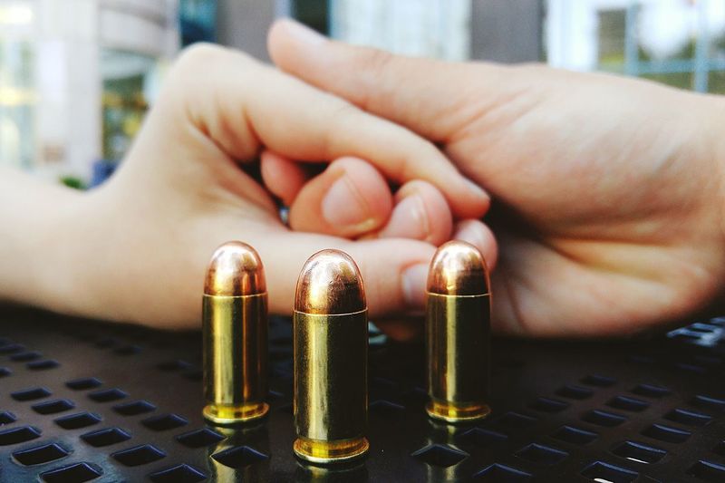 Close-up of hands and bullets