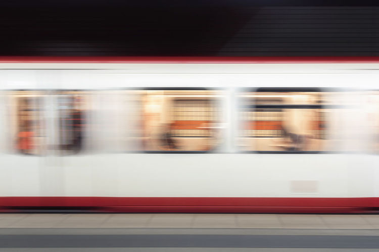 Blurred motion of train at railroad station
