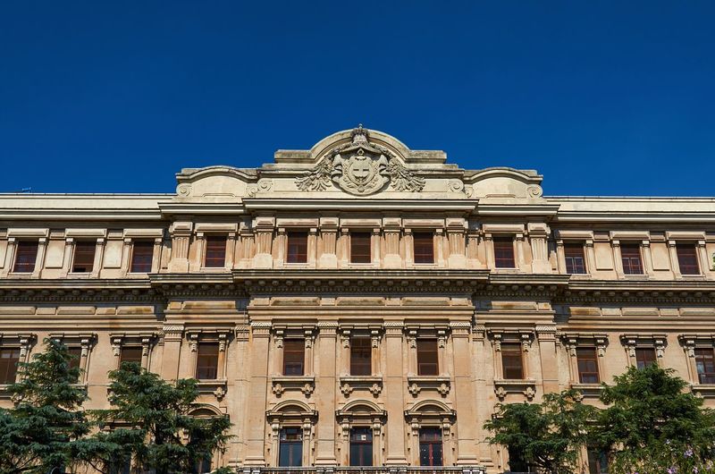 Low angle view of historical building against blue sky
