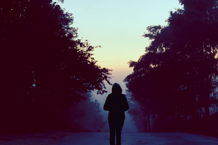 Rear view of silhouette woman standing against clear sky