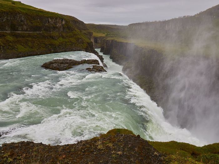 Scenic view of waterfall in sea