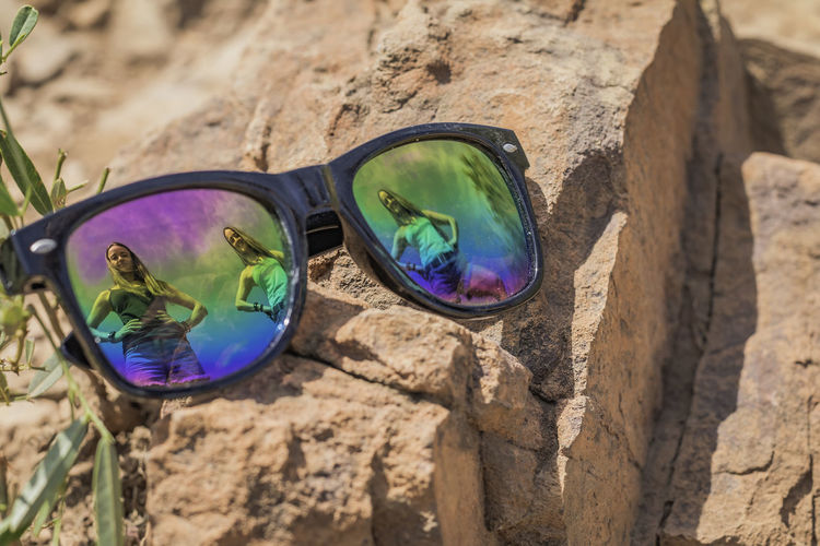 High angle view of sunglasses on rock