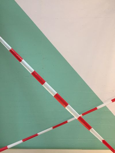 Close up of barrier tape in front of painted wall