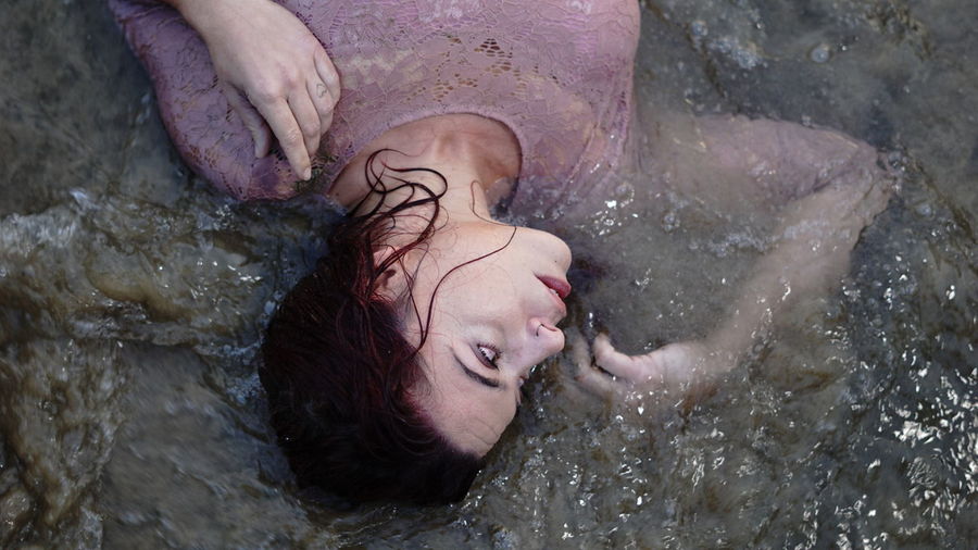 Portrait of young woman in water