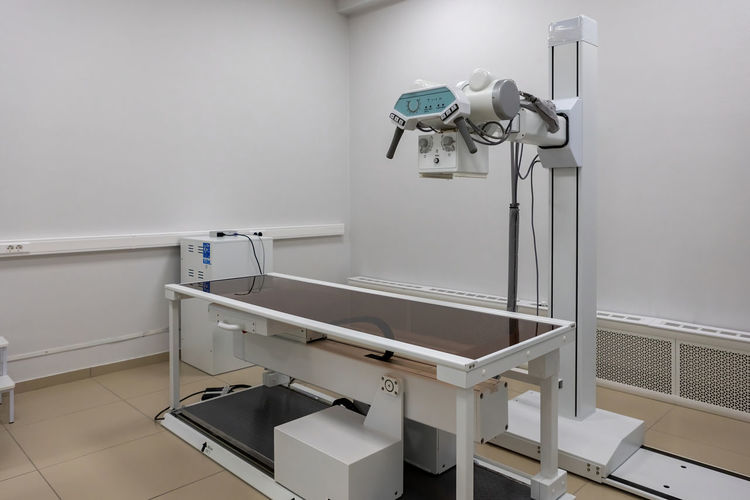 X-ray machine. an x-ray room with a scanning machine and an empty bed. scanning of the chest