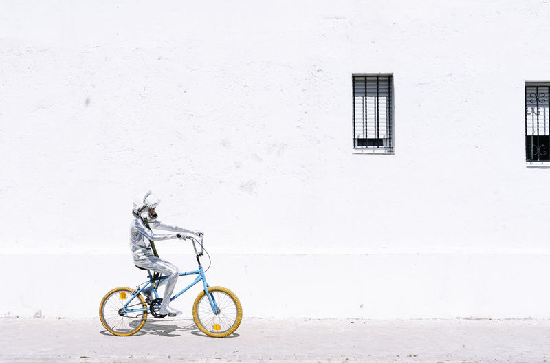 Bicycle parked on wall against building