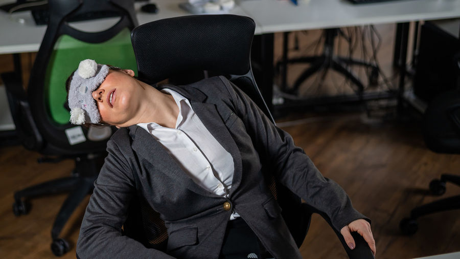 Overworked businessman sleeping at office