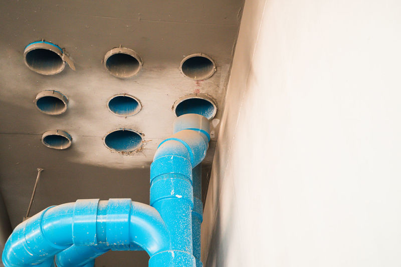 The location of the plumbing connection point is the large blue pvc pipe of the high-rise building.