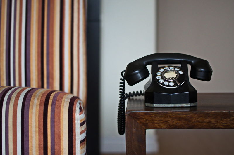 Close-up of rotary phone on table at home