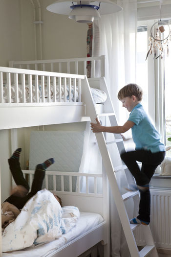 Boys playing on bunk bed
