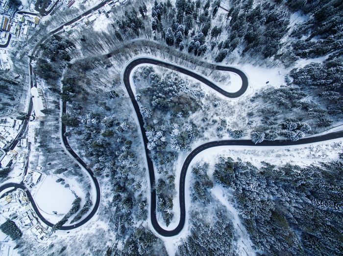 Aerial view of road at forest during winter