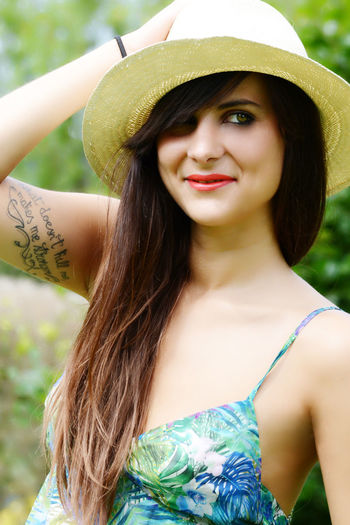 Smiling woman looking away while wearing hat
