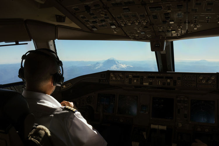 Rear view of pilot at aeroplane cockpit