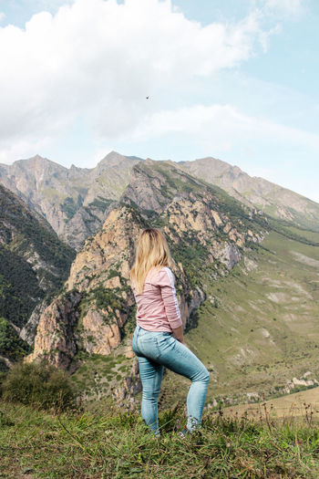 Woman standing against mountains