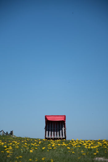 Lifeguard hut on field against clear sky