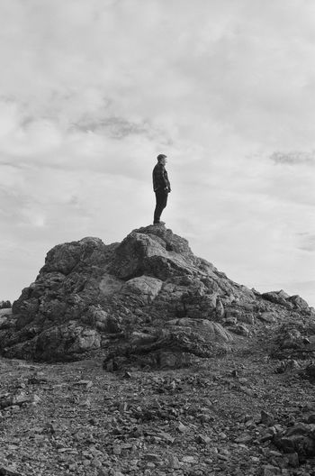 Rear view of man standing on rock formation