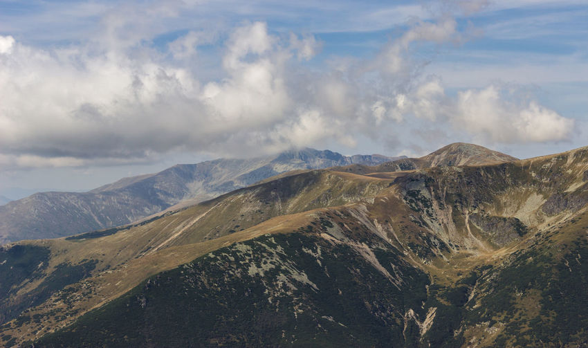 Scenic view of mountains against cloudy sky