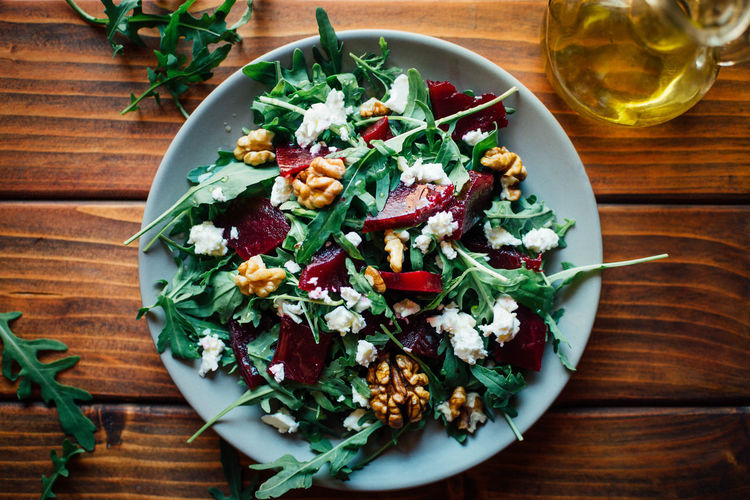 Arugula and beetroot salad with walnuts and feta cheese, top view