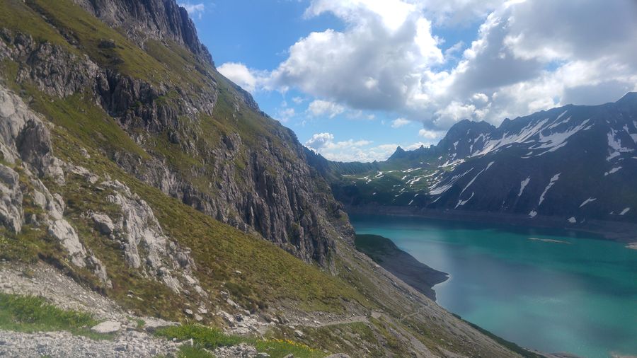 Scenic view of lake and mountains against sky