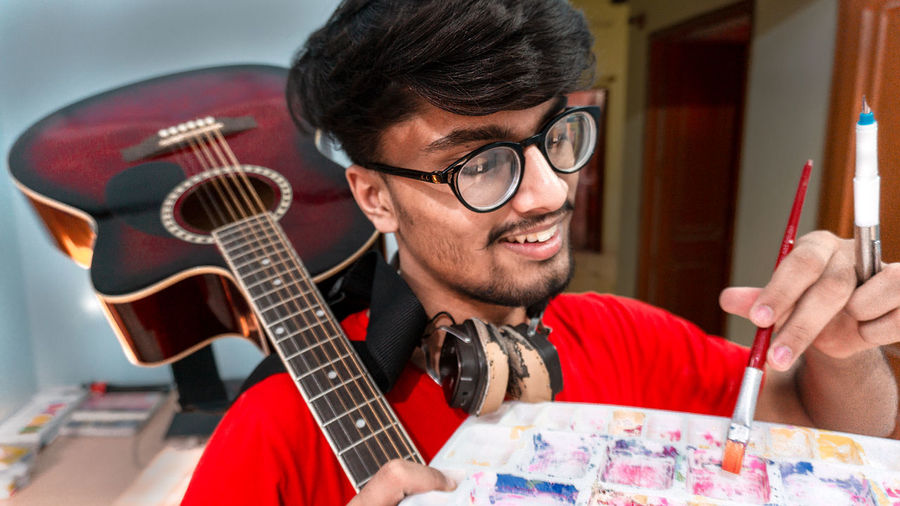 Portrait of a young man playing guitar