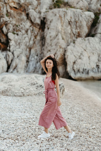 Full length portrait of woman walking at beach