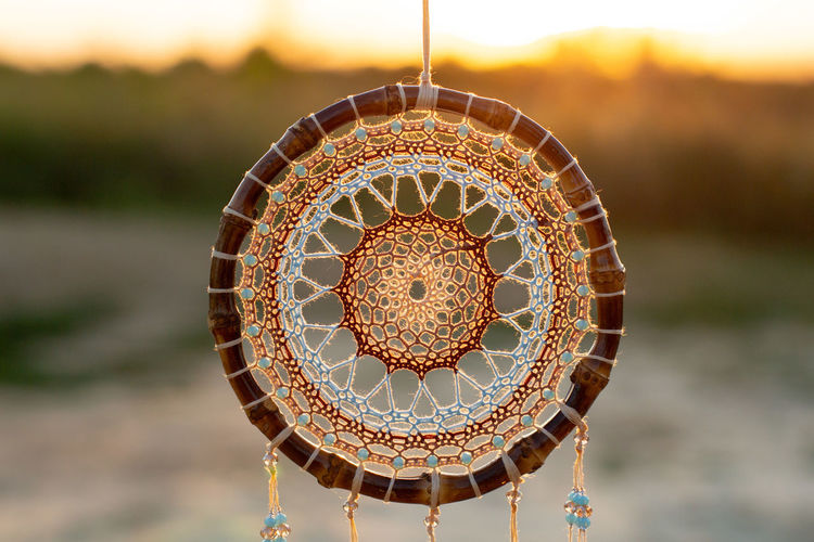 Close-up of illuminated lamp hanging from ceiling