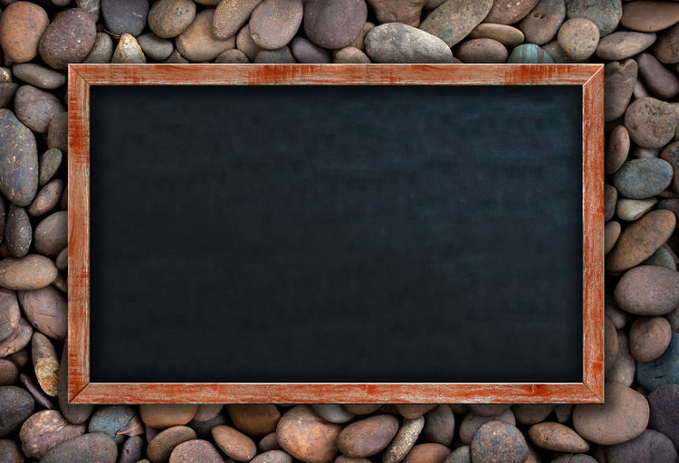 Directly above shot of writing slate on pebbles