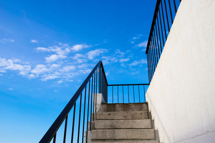 Low angle view of staircase against blue sky