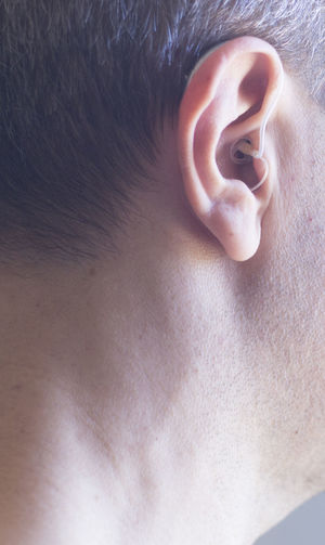 Close-up man wearing hearing aid