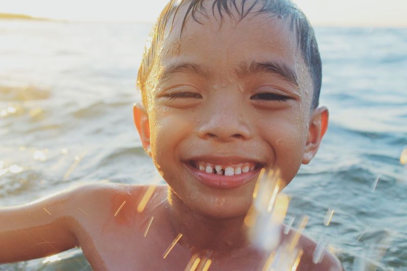 Portrait of smiling boy in sea