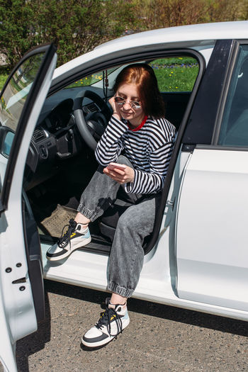 High angle view of woman sitting in car