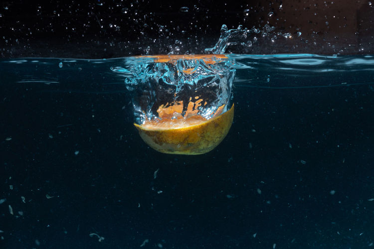 Close-up of water splashing against black background