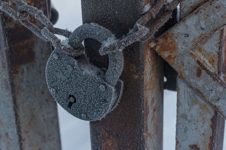 Close-up of rusty chain on snow