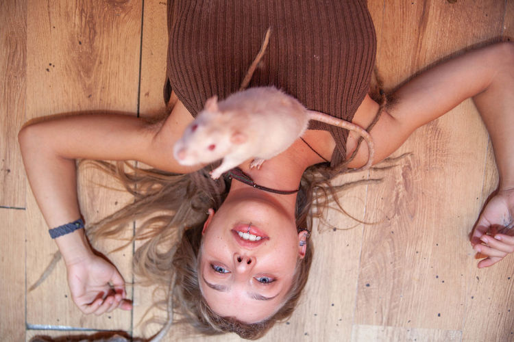 Cropped hand of woman with rat