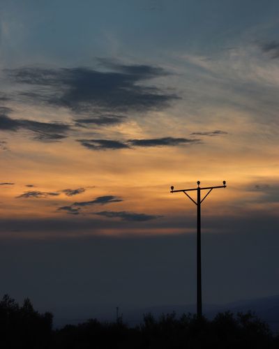 Low angle view of silhouette pole against sky during sunset