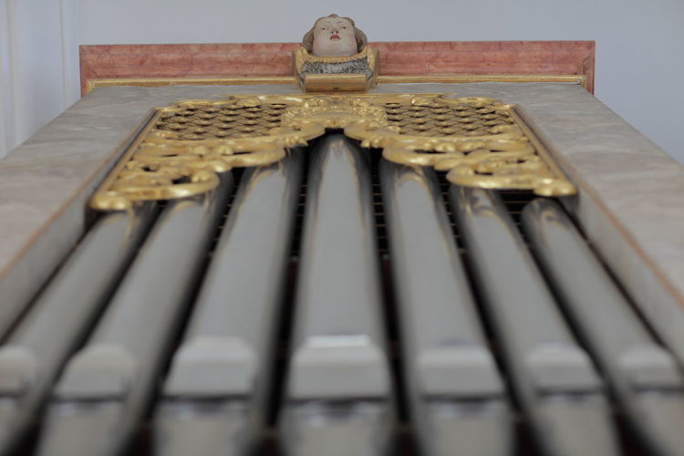 Low angle view of machine part on wall