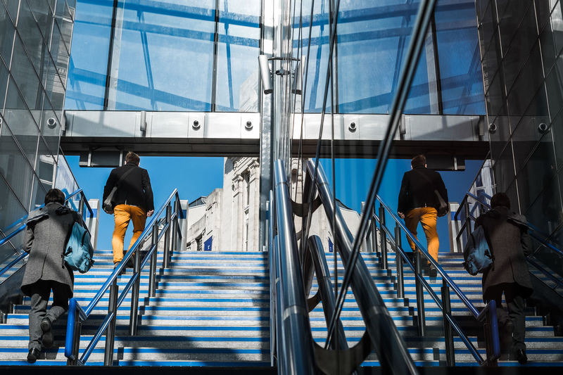 Rear view of people on staircase
