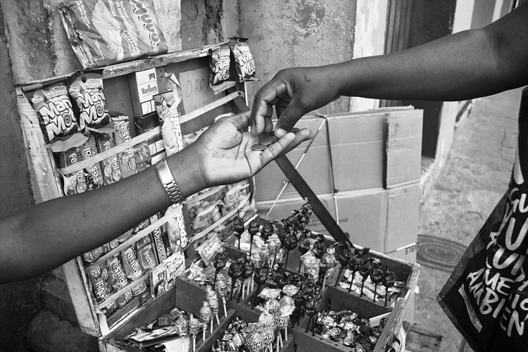 Cropped hand of customer giving money to vendor