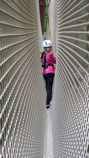 Portrait of girl on rope bridge