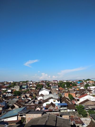 High angle shot of townscape against blue sky