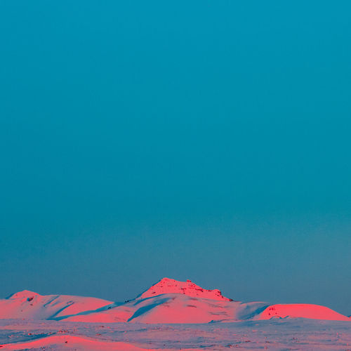 Idyllic shot of snowcapped mountains against clear blue sky