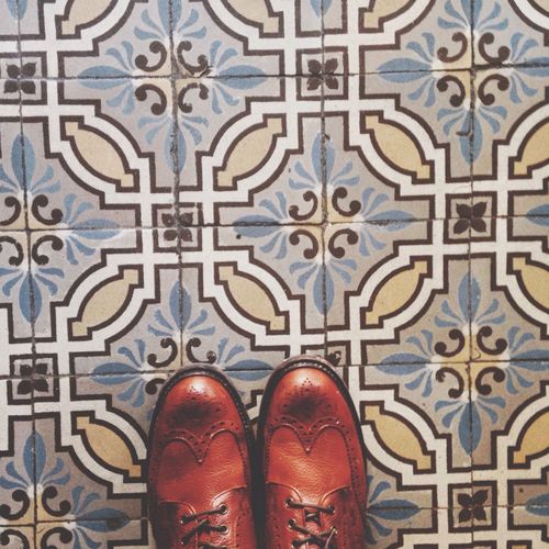 Leather shoes against designed flooring