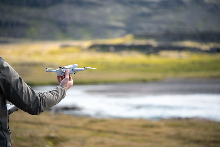 Cropped image of man holding drone
